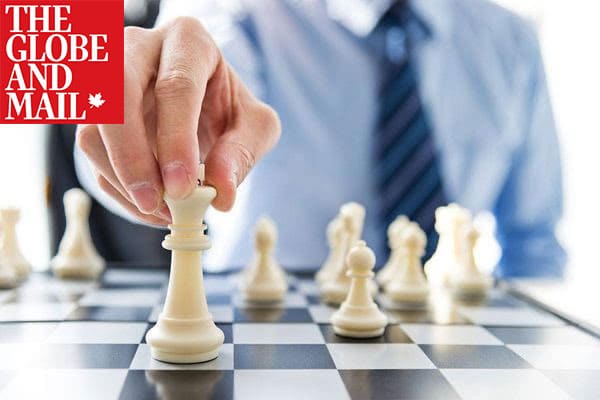 Man playing chess on a chess board with globe and mail logo at top left corner